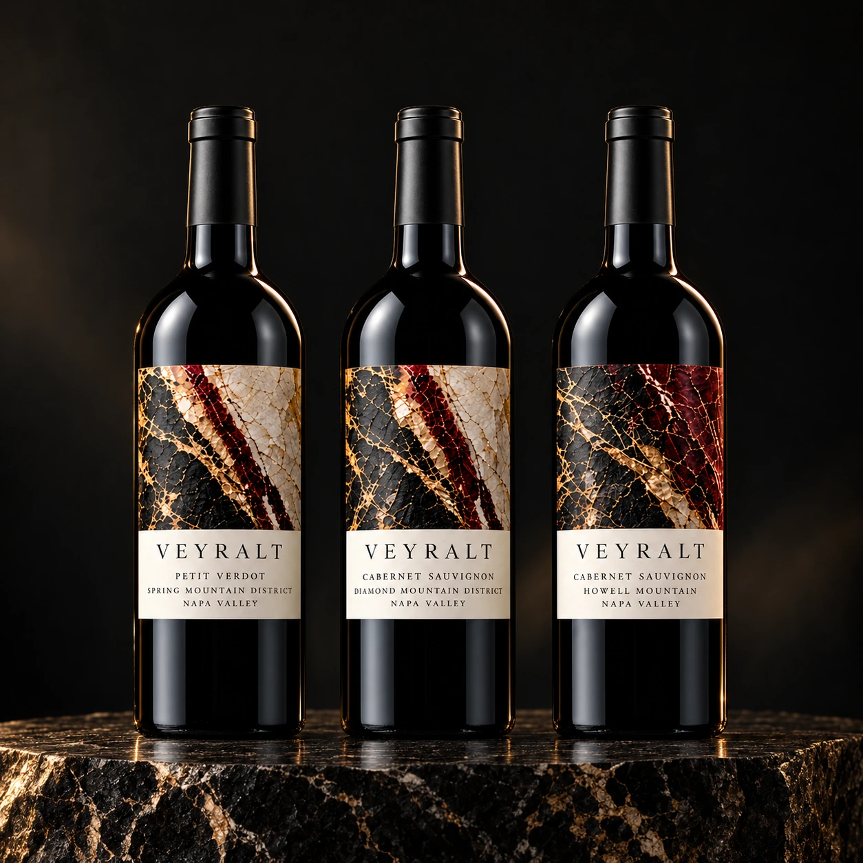 The VEYRALT three-bottle collection, with black, ivory, burgundy and gold mineral labels